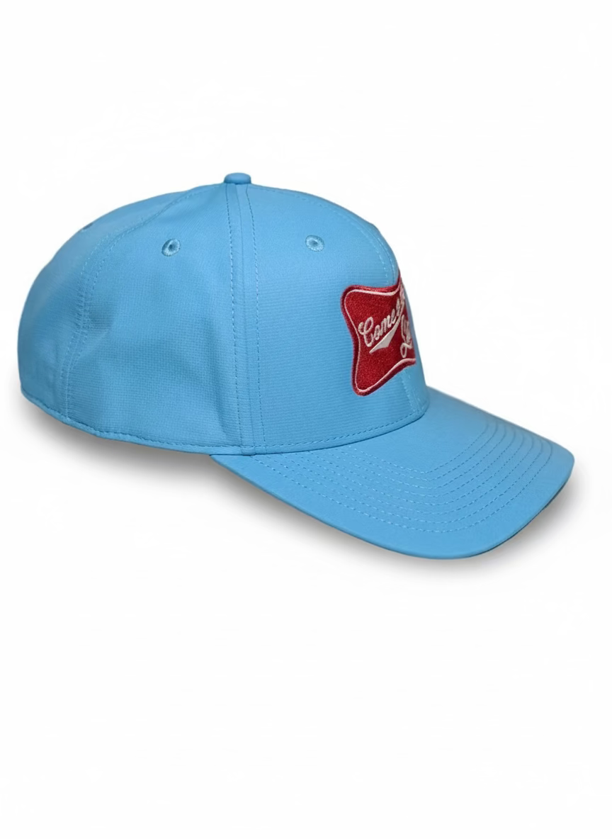 Blue cap with a red logo on a beige background