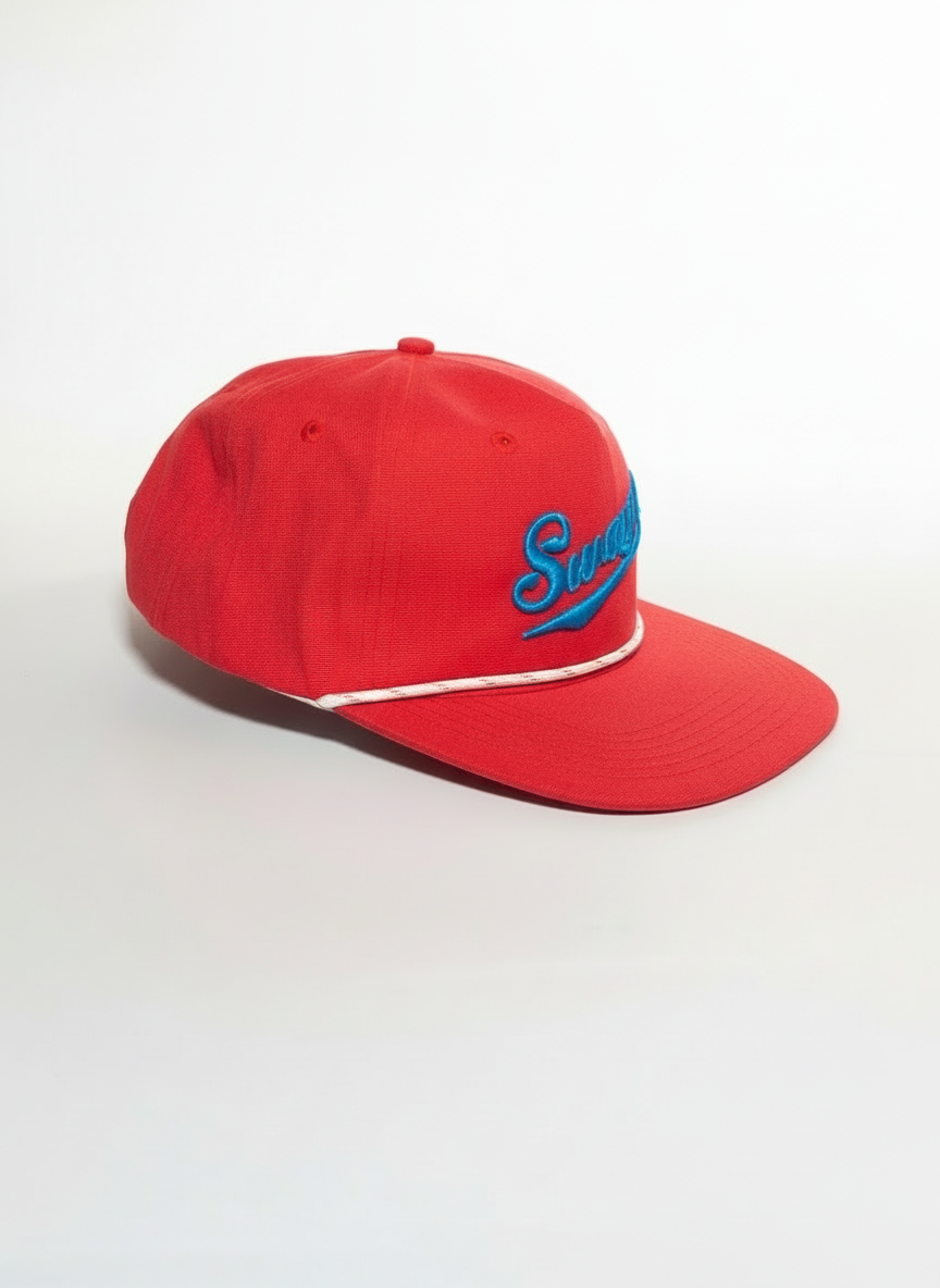 Side view of embroidered blue script "Swayze" of Ole Miss on a red hat with a white cord Lost Hat Co